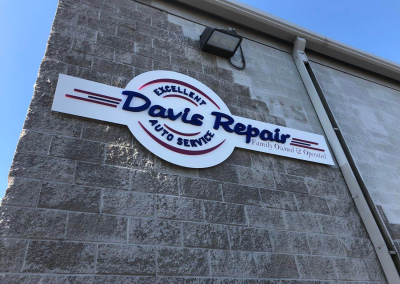 Davis Auto Repair exterior wall panel sign with dimensional acrylic brand logo Greenwood Village CO