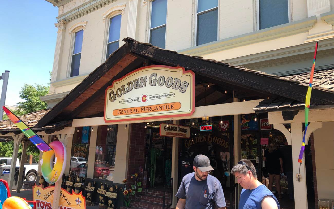 Custom wooden cabinet sign for Golden Goods General Mercantile in Golden, CO — outdoor storefront sign with decorative routed lettering and painted finish