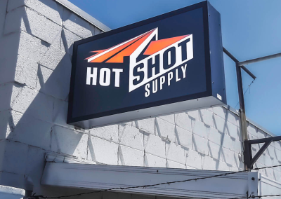 Hot Shot exterior illuminated projecting blade sign cabinet Cheyenne WY