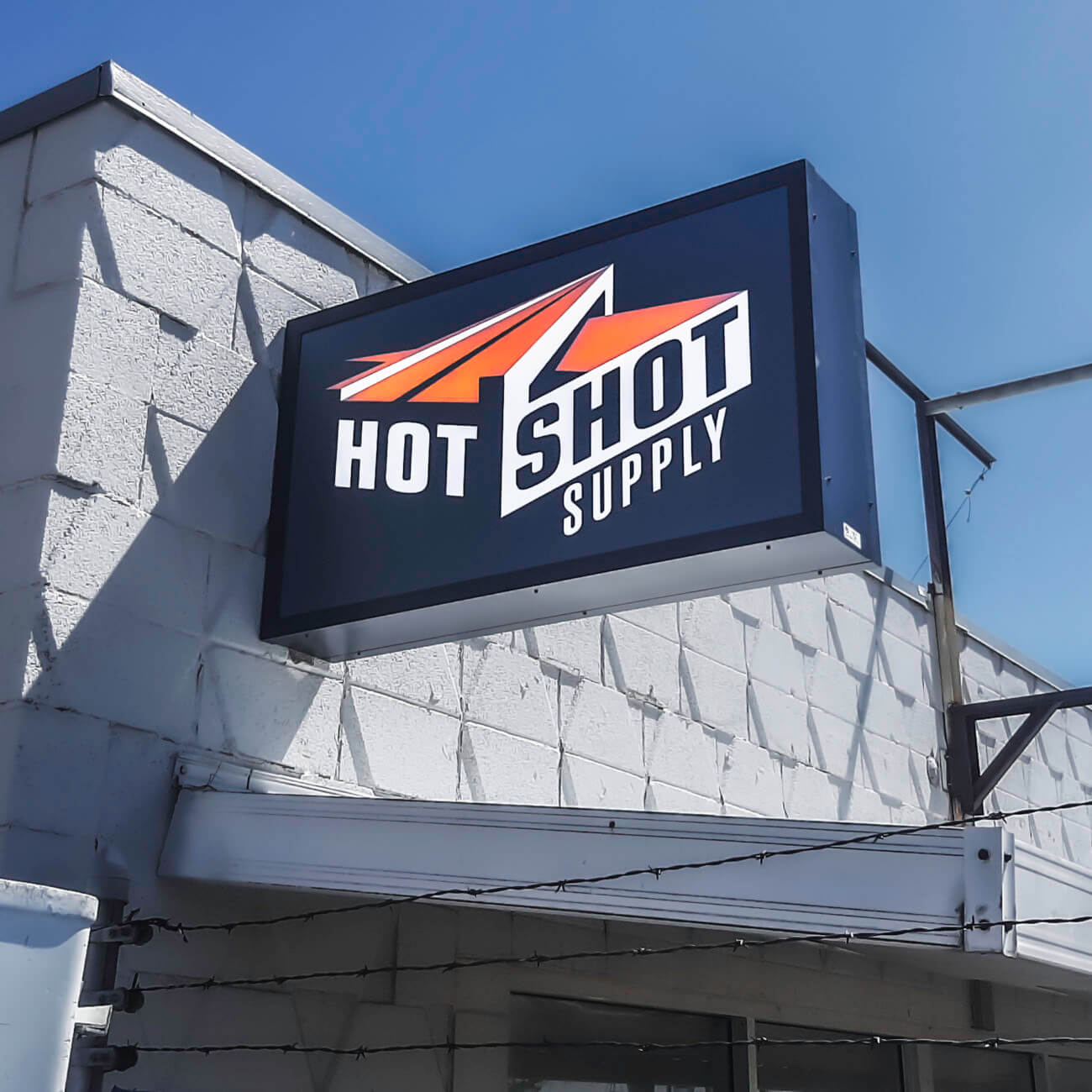 Hot Shot exterior illuminated projecting blade sign cabinet Cheyenne WY