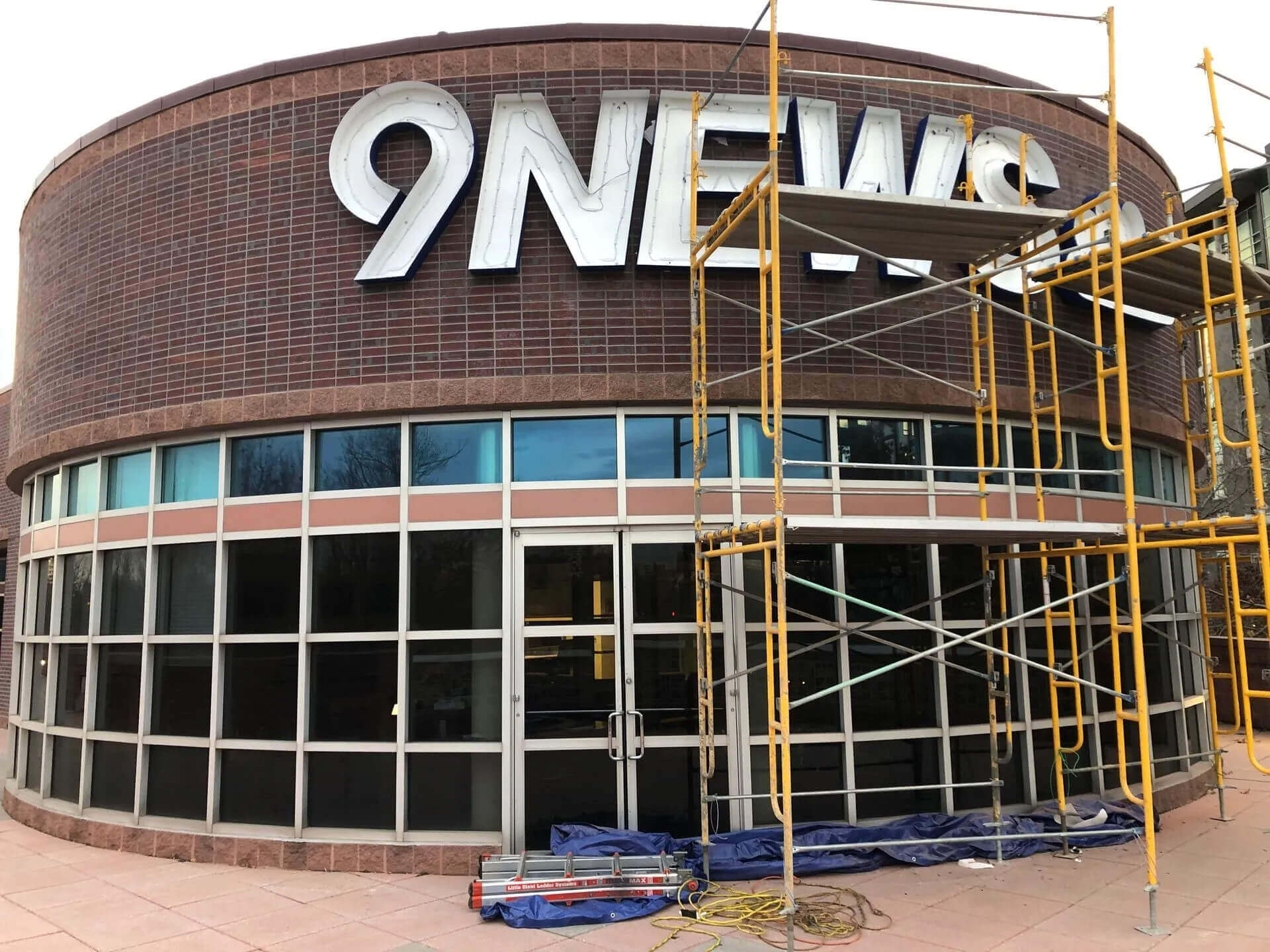 Vision Visual crew installing a commercial sign with a bucket truck in Denver CO