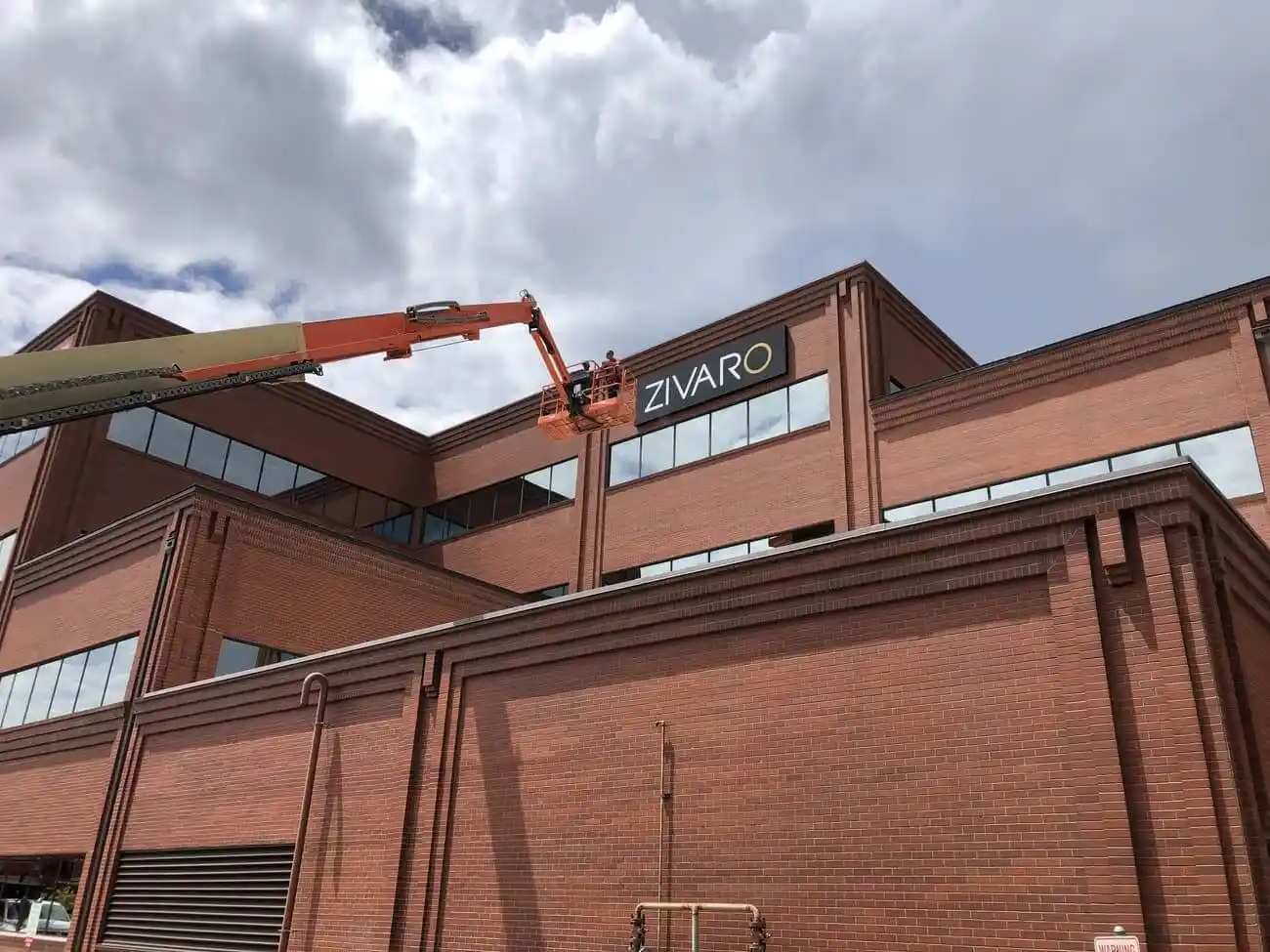 Zivaro Illuminated wall sign cabinet installation mid-rise building in Denver, CO