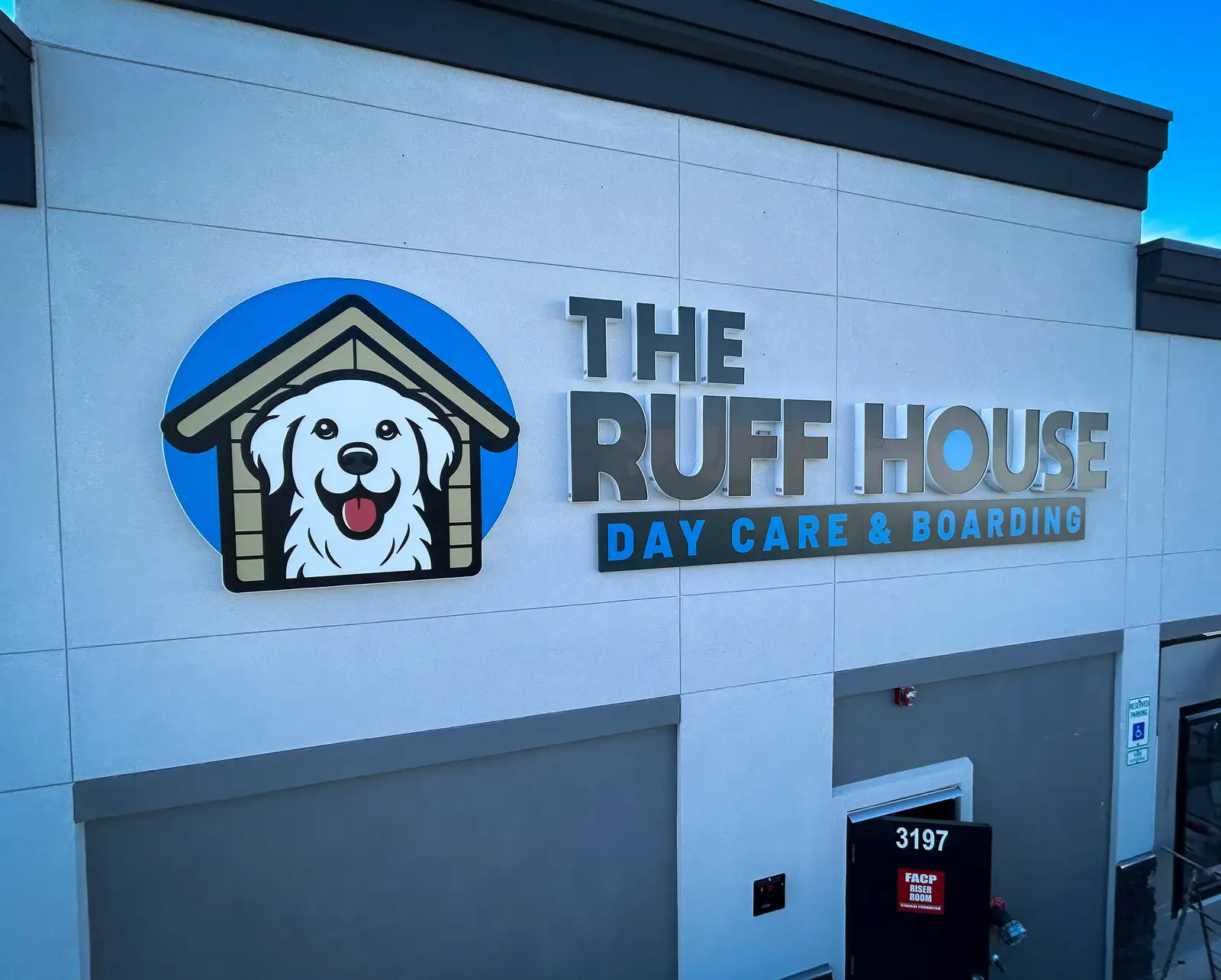 Custom dimensional letter sign and logo for The Ruff House Day Care & Boarding on a Denver commercial building